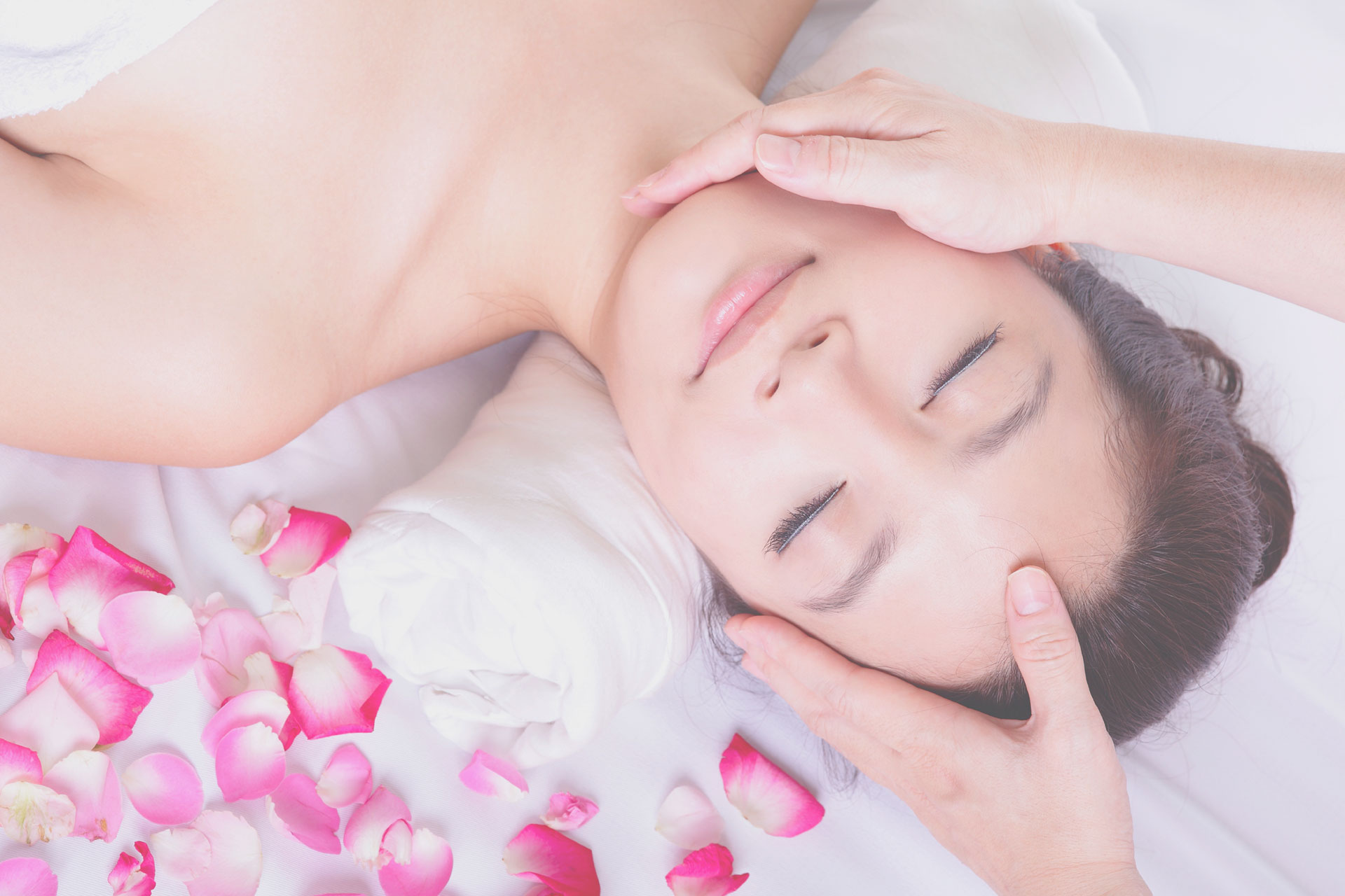 woman getting massage by flower petals